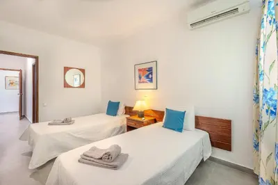 a room with two beds with towels on them at Vila Amélia by Sunnyway in Albufeira