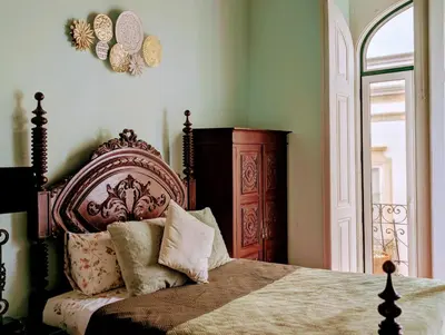 a bedroom with a bed and a wooden headboard at Grand Studio 54 in Faro