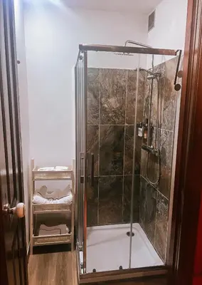 a shower with a glass enclosure in a bathroom at Grand Studio 54 in Faro