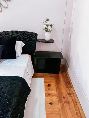 a bedroom with a bed and a table with a plant at Grand Studio 54 in Faro