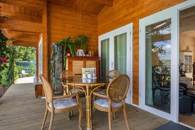 a dining room with a table and chairs on a porch at Design Chalet in Albufeira With Private Pool in Albufeira