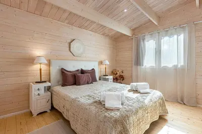 a bedroom with a bed and a wooden wall at Design Chalet in Albufeira With Private Pool in Albufeira