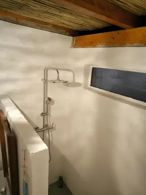 a bathroom with a light on a white wall at Design Chalet in Albufeira With Private Pool in Albufeira