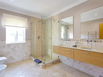 a bathroom with a shower and a sink and a tub at Villa Amendoeiras V6 - VIP Properties by Interhome in Albufeira