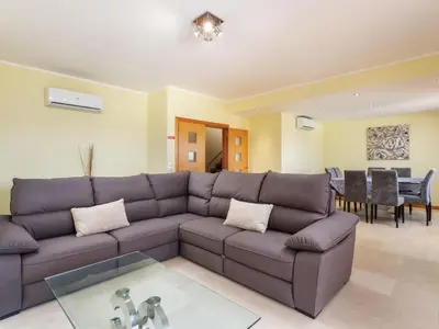 a living room with a couch and a table at Apartment Triplex Vilamoura VIP Properties by Interhome in Vilamoura