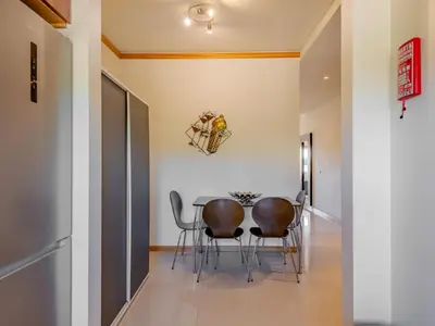a room with a table and chairs on a patio at Holiday Home Cerro Aguia AM V2 - VIP Properties by Interhome in Albufeira