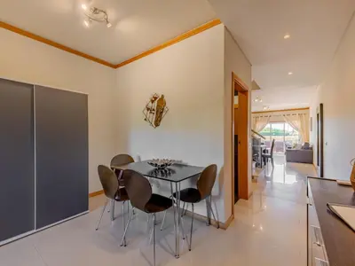a table and chairs on a patio with a table at Holiday Home Cerro Aguia AM V2 - VIP Properties by Interhome in Albufeira