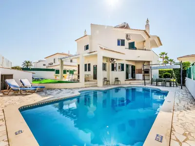 a villa with a swimming pool and a house at Villa Monteiro V4 - VIP Properties by Interhome in Albufeira