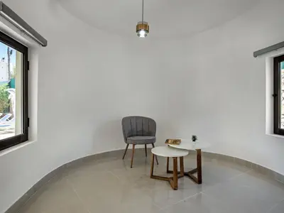 a chair and a table in a room at Villa Corcovada V4 VIP Properties by Interhome in Albufeira