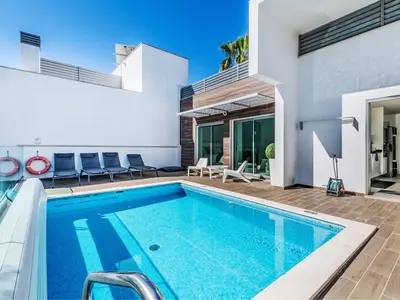 a patio with couches and chairs on a roof at Villa Sónia Lote 69 - VIP Properties by Interhome in Albufeira