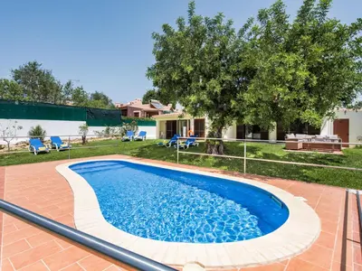 a swimming pool in the backyard of a house at Villa Jenny - VIP Properties by Interhome in Albufeira