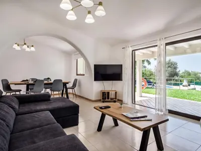 a living room with a couch and a table at Villa Jenny - VIP Properties by Interhome in Albufeira