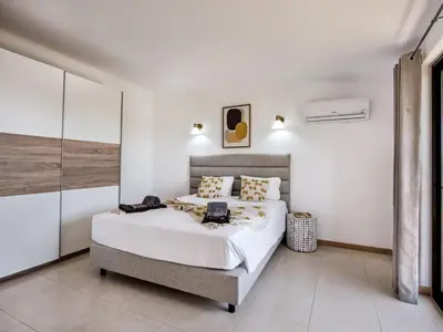 a bedroom with a large bed with white walls at Villa Jenny - VIP Properties by Interhome in Albufeira