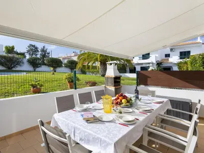 a balcony with a table and chairs and a swimming pool at Holiday Home Pierre by Interhome in Galé