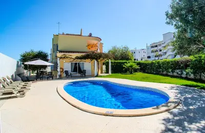 a large blue swimming pool in front of a building at Villa Orange with private pool Albufeira in Albufeira