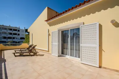 a bathroom with a sink and a washing machine at Villa Orange with private pool Albufeira in Albufeira
