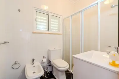 a bedroom with a bed and a dresser with two towels at Villa Orange with private pool Albufeira in Albufeira