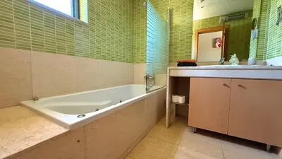 a bathroom with a tub and a sink and a toilet at Villa Paula with Private Pool Close to the Beach and Strip in Albufeira