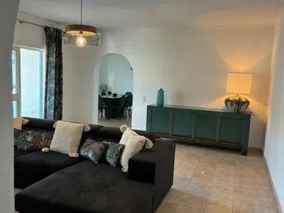 a living room with a black couch and a table at Villa GALVANA in Guia