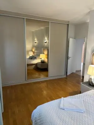 a room with a bedroom with a bed and a mirror at Villa GALVANA in Guia