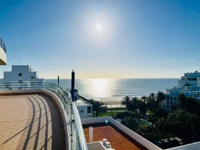 a view of the ocean from the balcony of a building at Pérola do Algarve in Quarteira