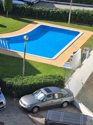 a car parked in front of a swimming pool at AREIAS SOL in Albufeira