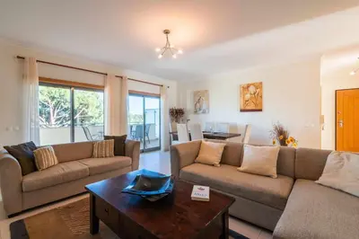 a living room with two couches and a table at Balaia Residense Penthouse 2 Bedroom Apartment with Pool in Albufeira