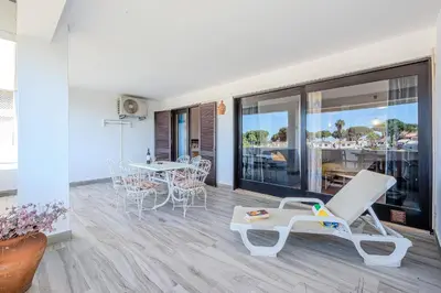 a room with a patio with a table and chairs at Apartamento Ivone by Sunnyway in Albufeira