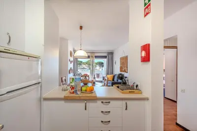 a kitchen with white cabinets and a counter top at Apartamento Ivone by Sunnyway in Albufeira