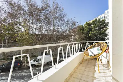 a balcony with a white railing and a chair at Blue Peacock in Faro