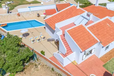 an aerial view of a house with a swimming pool at Villa Mar do Estrela in Galé