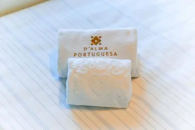 a piece of white soap sitting on a bed at Apartment - Vilamoura Pine By Dalma Portuguesa in Quarteira