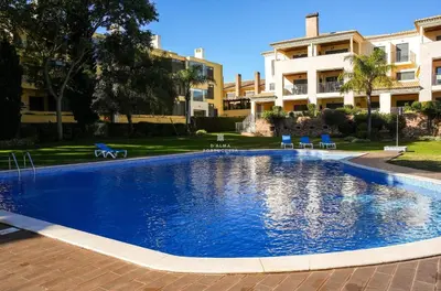 a large swimming pool in front of a building at Apartment - Vilamoura Pine By Dalma Portuguesa in Quarteira