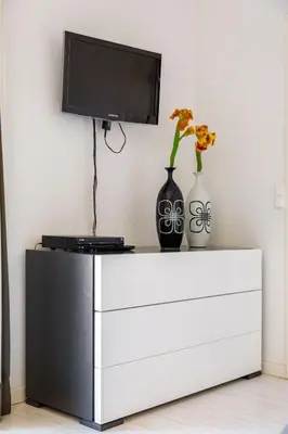 a tv on top of a white dresser with vases at Charming Vale Do Lobo Villa 4 Bedrooms Villa Quadradinhos 22 Private Pool in Almancil