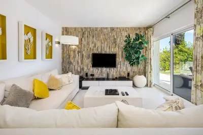 a living room with a white couch and a tv at Charming Vale Do Lobo Villa 4 Bedrooms Villa Quadradinhos 22 Private Pool in Almancil