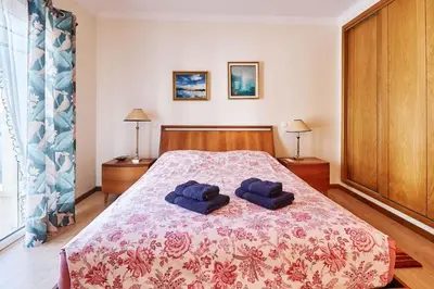 a bedroom with a bed with two blue towels on it at NEU - Casa Tina mit Meerblick und Pool in Guia