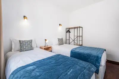 two beds sitting next to each other in a room at Mar&Mar Old Town 2 Bedroom Apartment in Albufeira