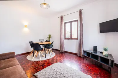 a living room with a table and chairs at Mar&Mar Old Town 2 Bedroom Apartment in Albufeira