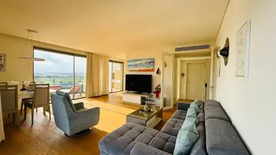 a living room with a couch and a table at Two Bedroom Laguna Village - By Vilamoura Sun in Quarteira