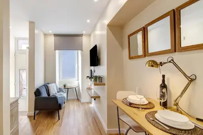 a bedroom with two beds and a mirror at Bougainvillea House in Faro