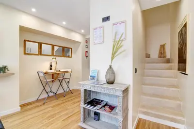 a living room with a fireplace and stairs at Bougainvillea House in Faro