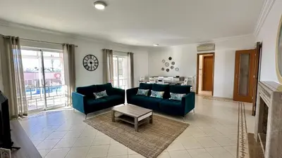 a living room with two blue couches and a table at Antonieta by Check-in Portugal in Albufeira