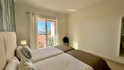 a bedroom with a large bed and a window at Antonieta by Check-in Portugal in Albufeira