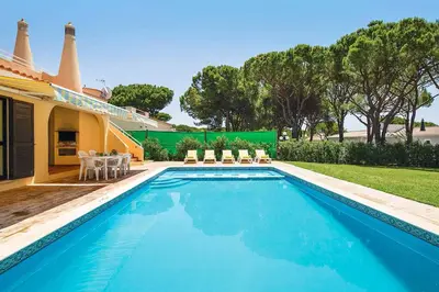 a swimming pool in the backyard of a house at Villa Daffodil Golf in Vilamoura