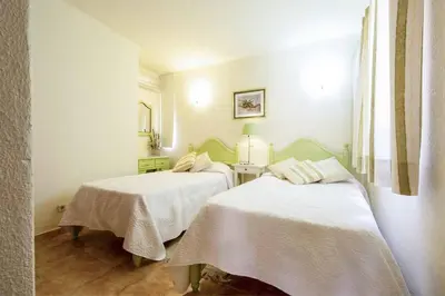 a bedroom with two beds with white sheets at Villa Daffodil Golf in Vilamoura