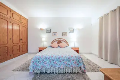 a bedroom with a bed and two tables and two lamps at Villa Mica in Azinhal