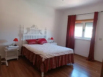 a bedroom with a bed with red pillows on it at Holiday HouseV5 W/Pool & BBQ in Albufeira