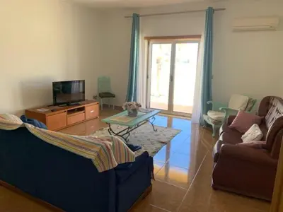 a living room with a couch and a coffee table at Holiday HouseV5 W/Pool & BBQ in Albufeira
