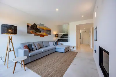 a living room with a couch and a tv at Casa Esmarand in Albufeira
