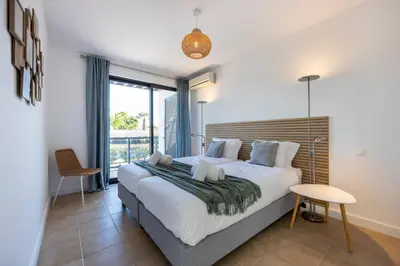a bedroom with a large bed and a large window at Casa Esmarand in Albufeira